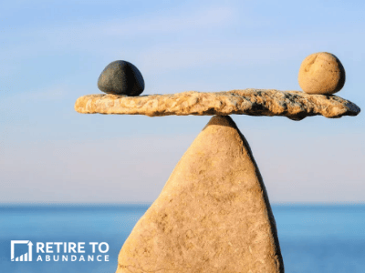 image of rocks balancing perfectly on each other in front of an ocean background