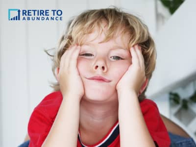 young boy with hand on cheeks looking bored