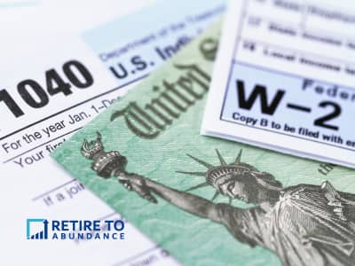 a pile of documents including form 1040, W-2 and a colored pencil drawing of the statue of liberty
