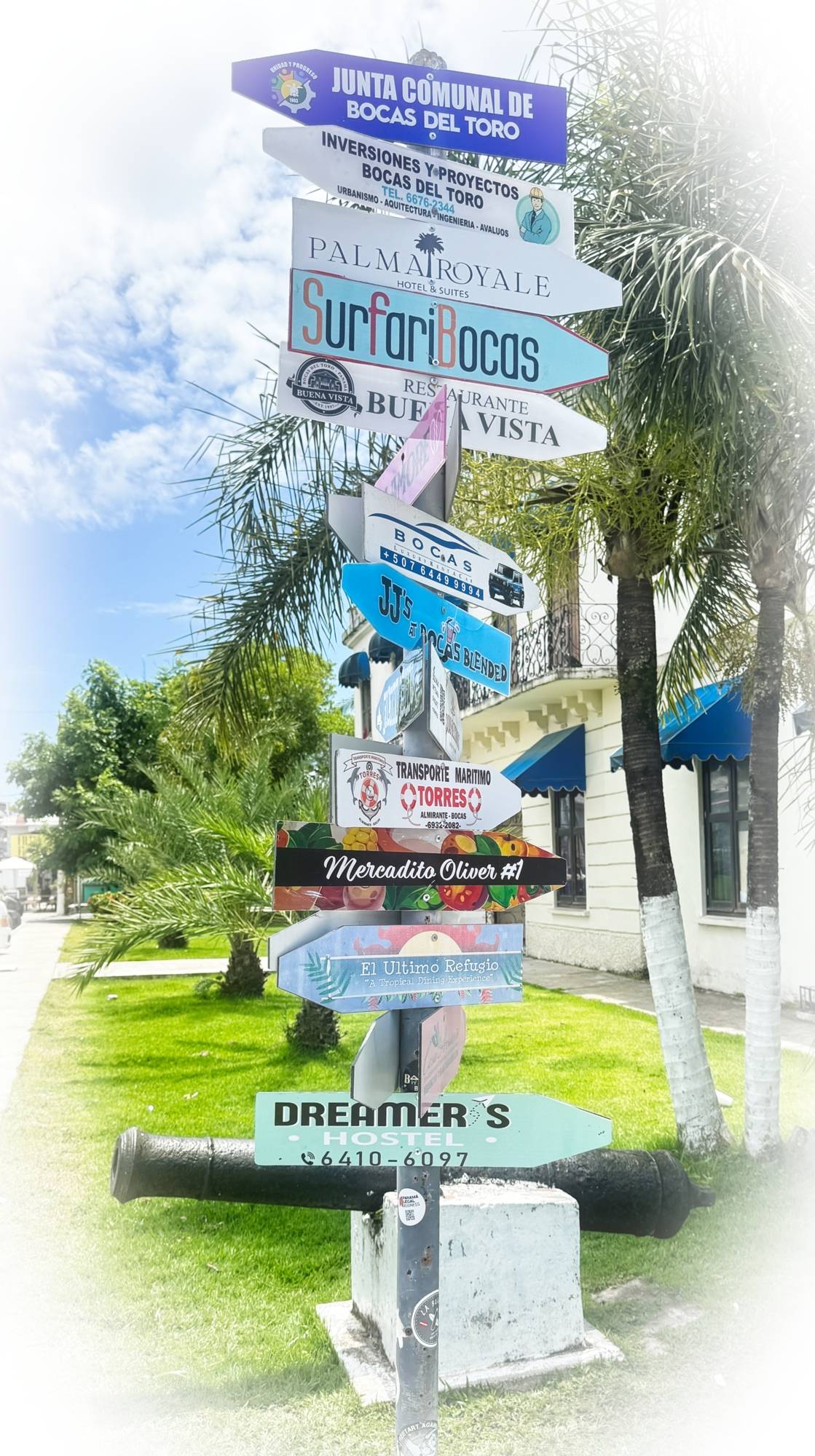 Street sign with a dozen wayfinding signs to restaurants and town sites. 