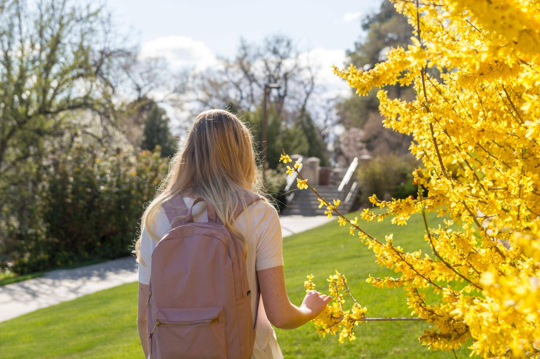 Female Student Walking on College Campus During the Spring