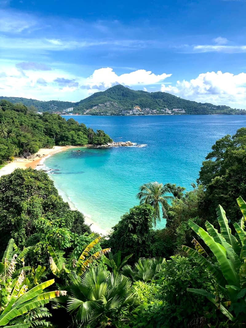 a view of a tropical beach from a hill