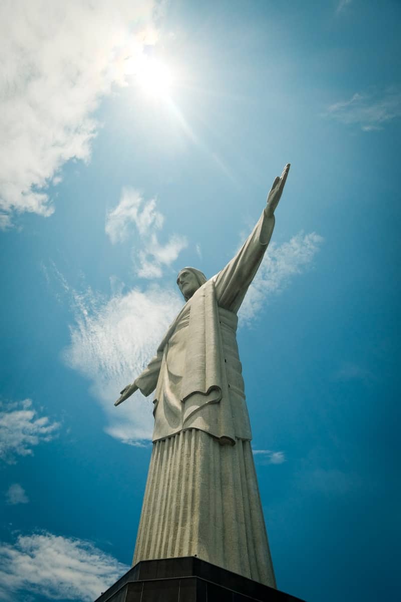 Christ the redeemer statue against a bright blue sky