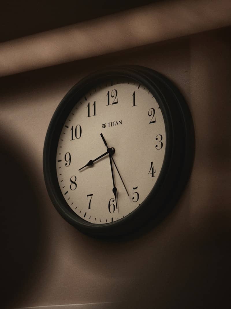 A round wall clock showing 8:09