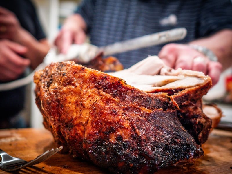 A large piece of meat sitting on top of a wooden cutting board