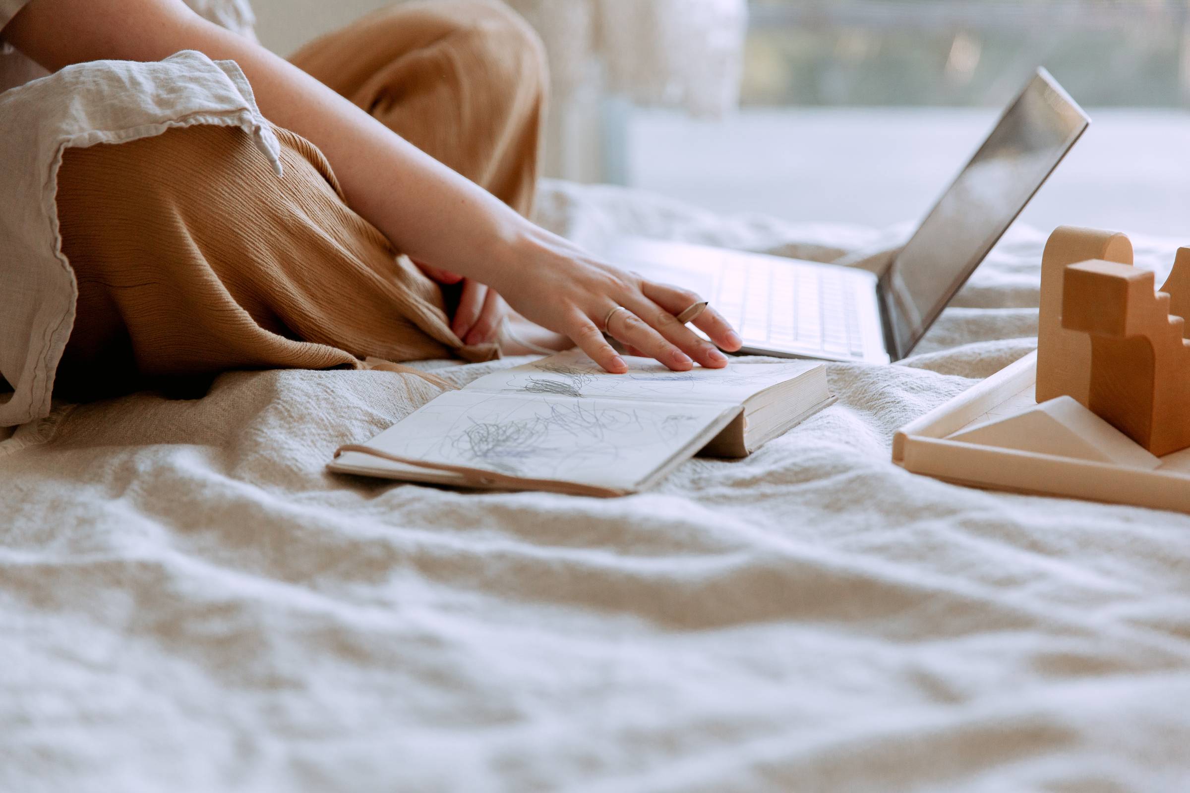 woman in white shirt lying on green leaves