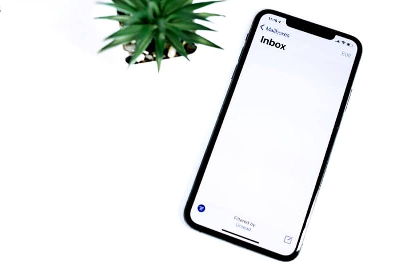 black iphone 5 on white surface