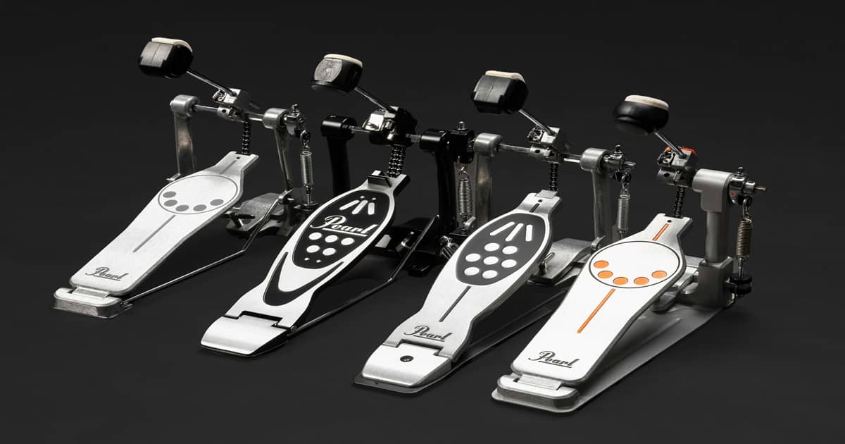 A row of different drum pedals sitting next to each other