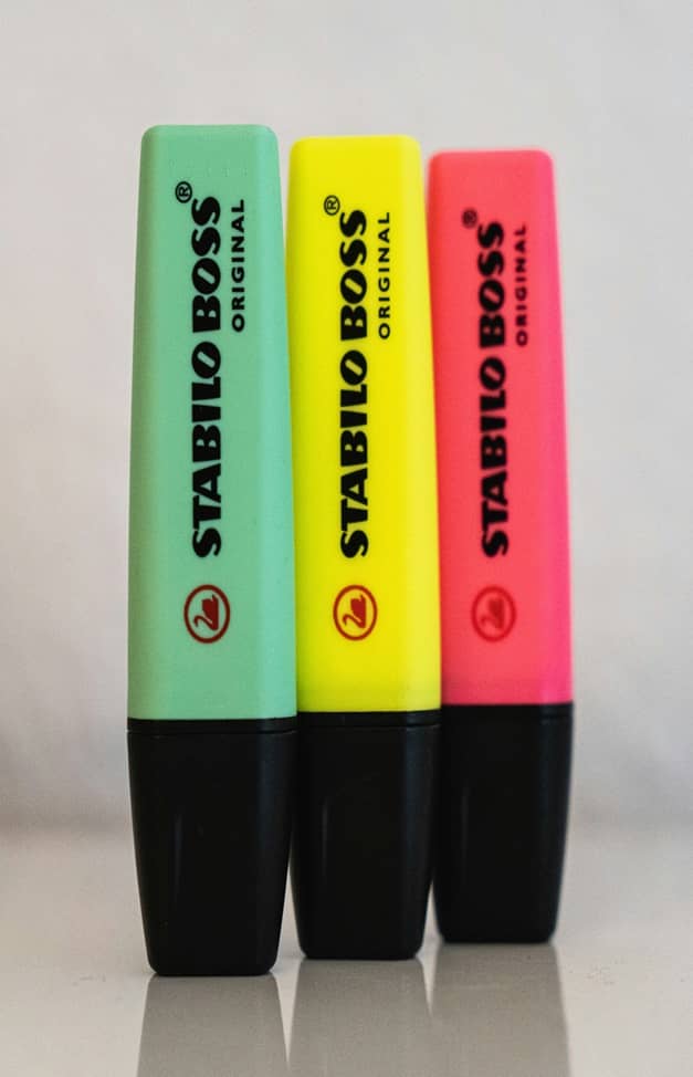 A set of markers stacked next to each other.