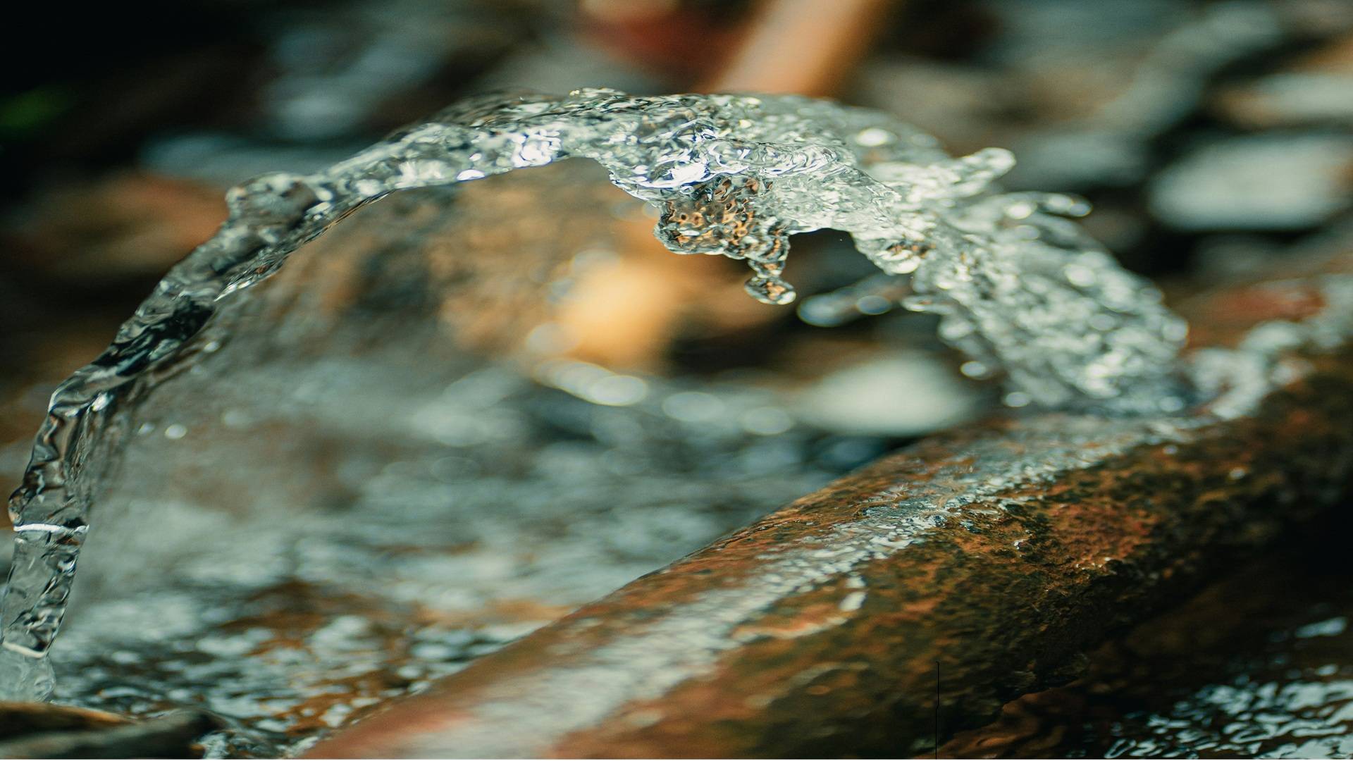 Pipe with water leaking from a crack.