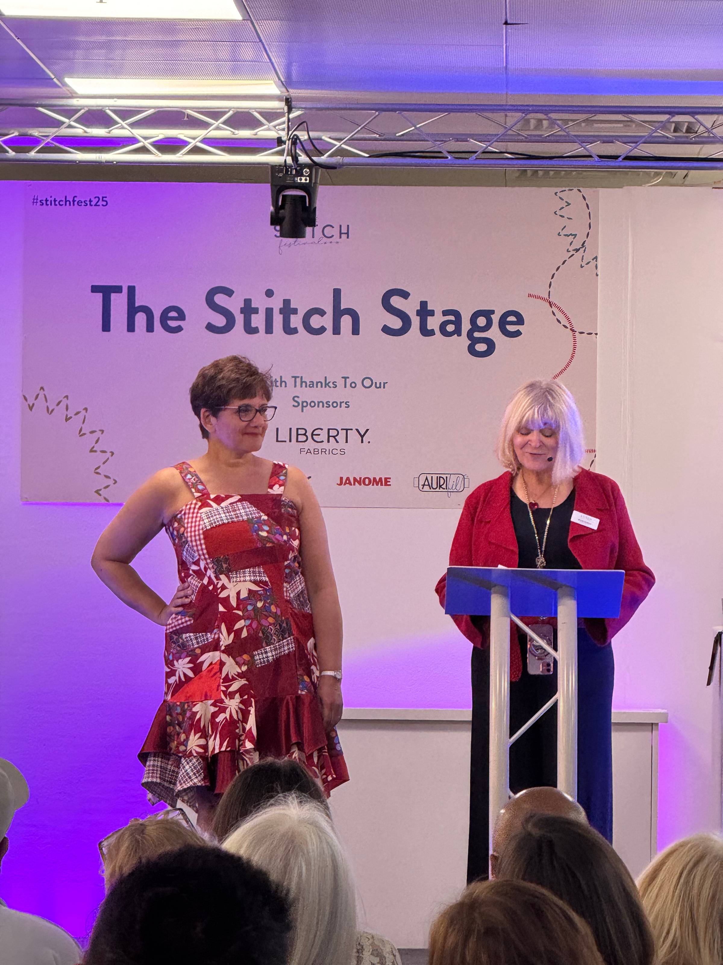 Vee modelling her scrappy red dress on the catwalk