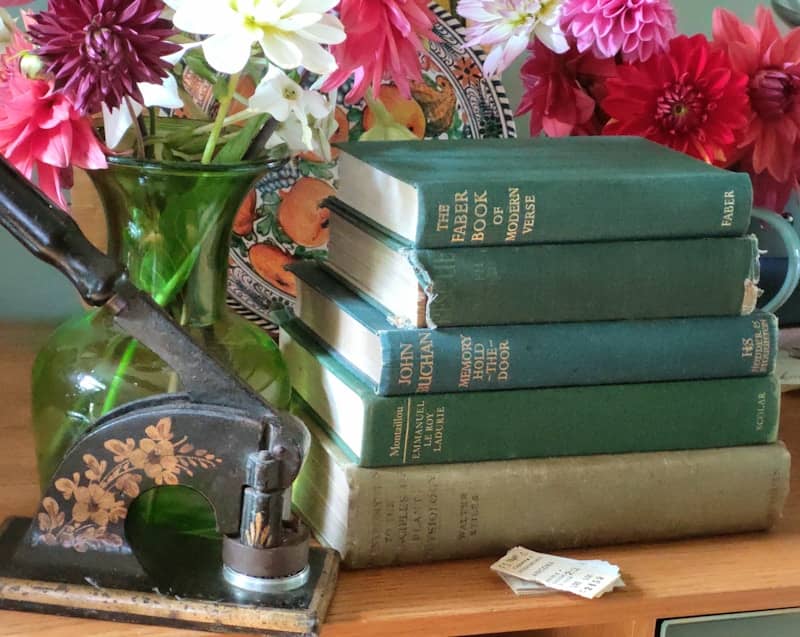 A stack of books sitting on top of a wooden table