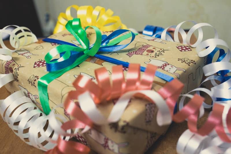 brown and white cake with assorted color ribbon