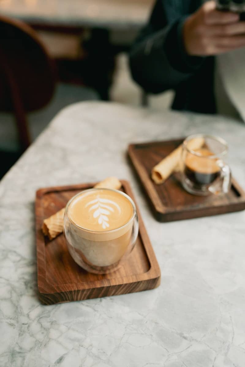 A cup of coffee and a plate of food on a table