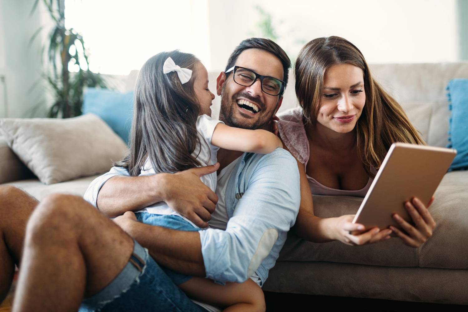 a mom reading her business notes with dad and daughter laughing nearby