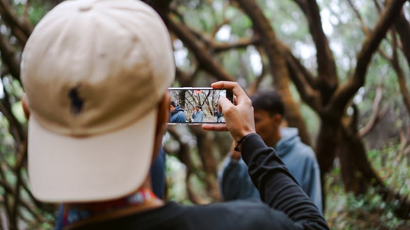 A person taking a video with a cell phone