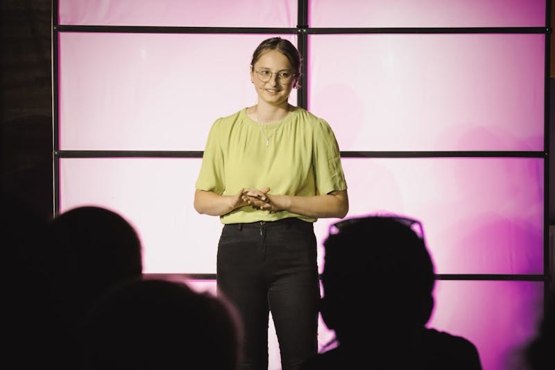 A woman standing on a stage in front of a crowd