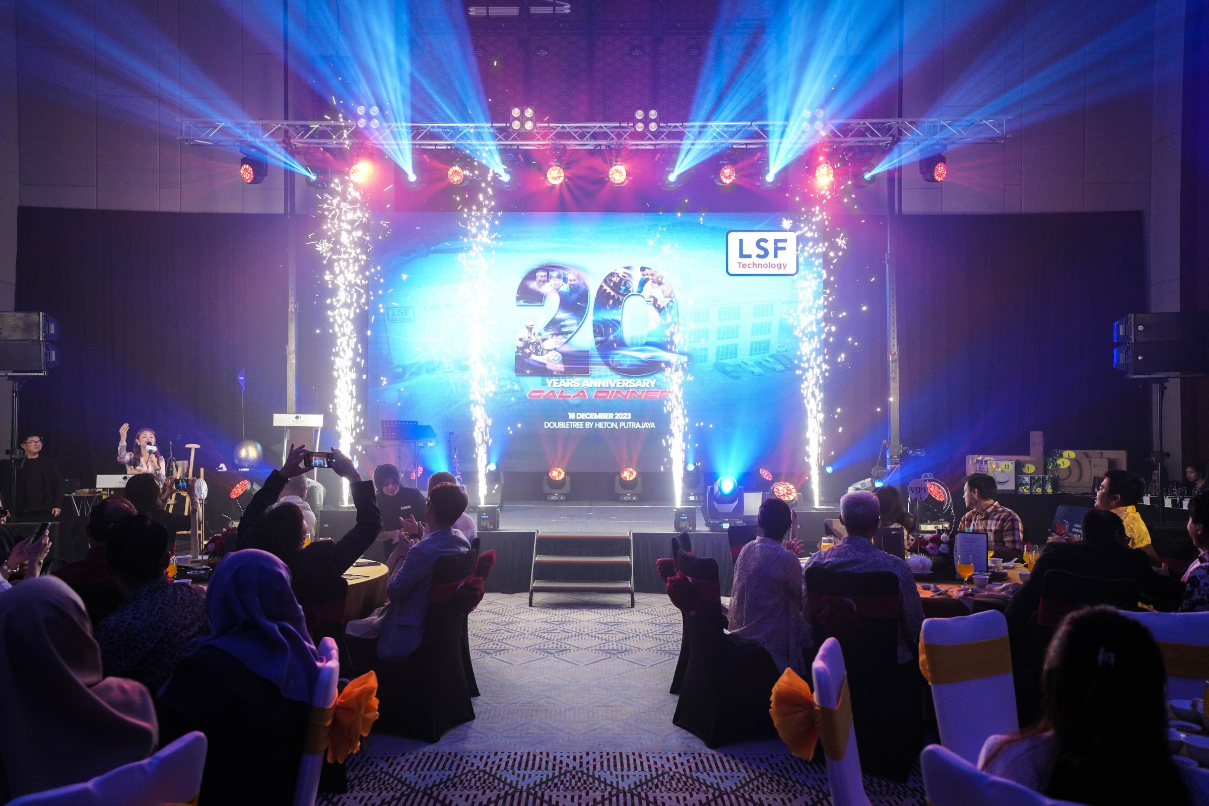 A group of people standing in front of a stage