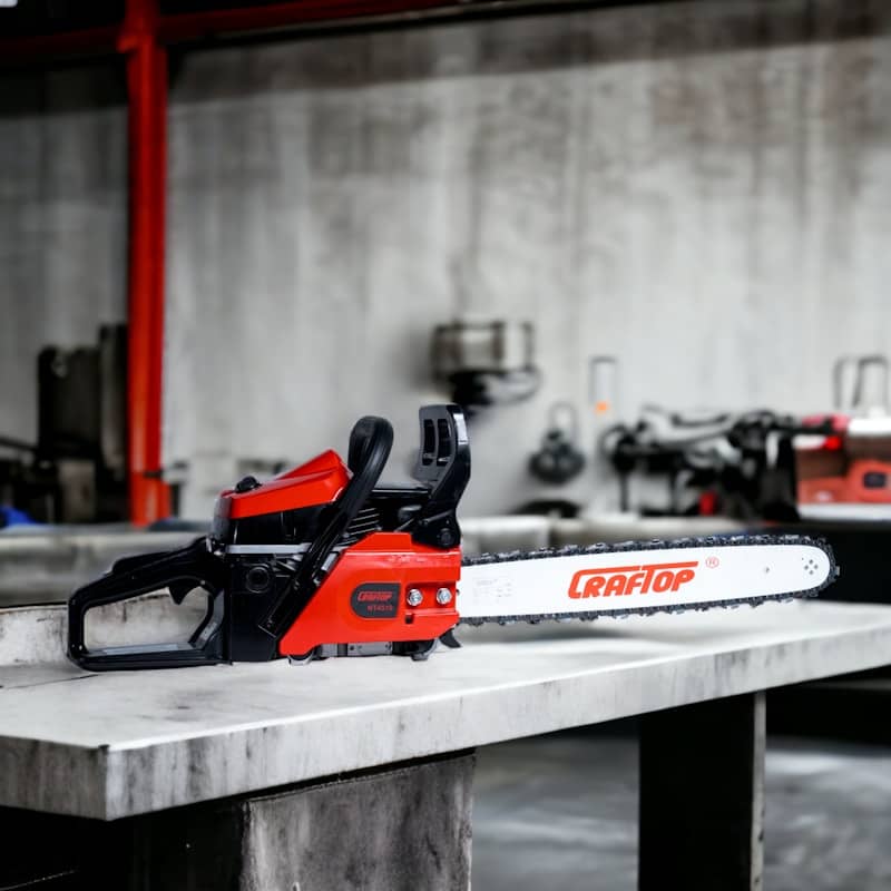 a red and black chainsaw sitting on top of a table