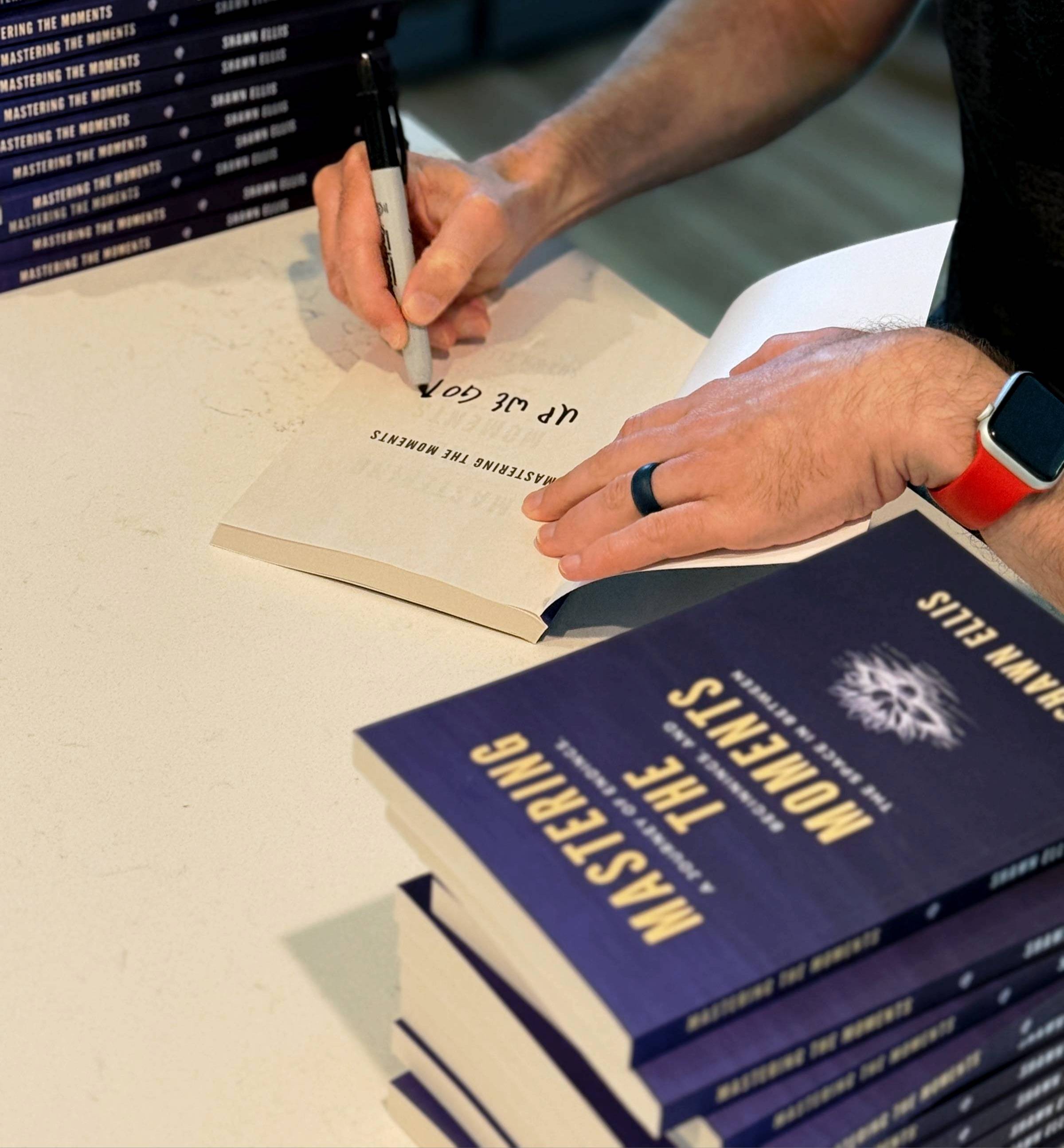 Shawn Ellis signing copies of Mastering the Moments