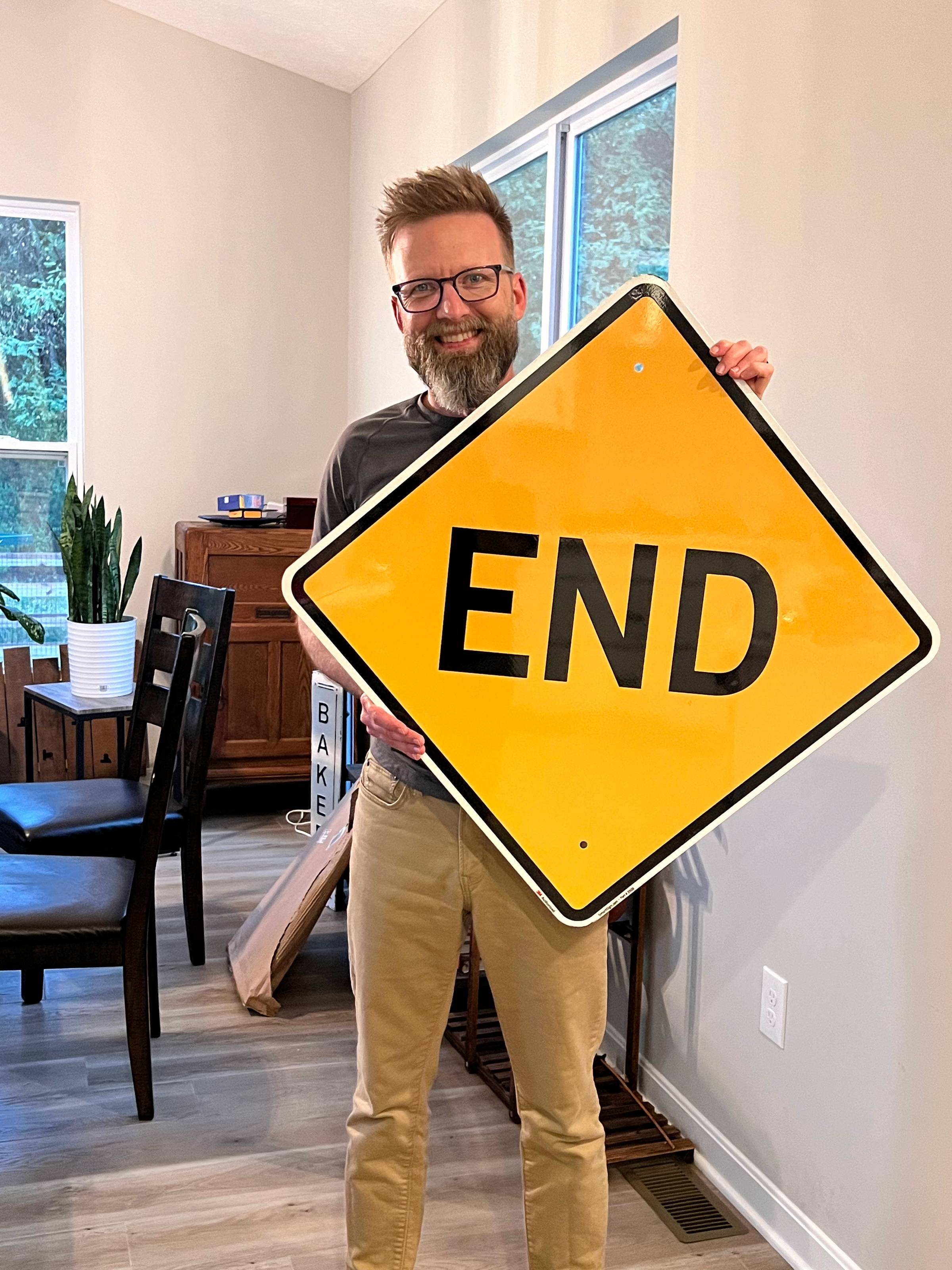 Shawn holds END sign