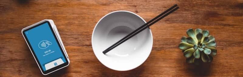black chopsticks in white ceramic bowl on table