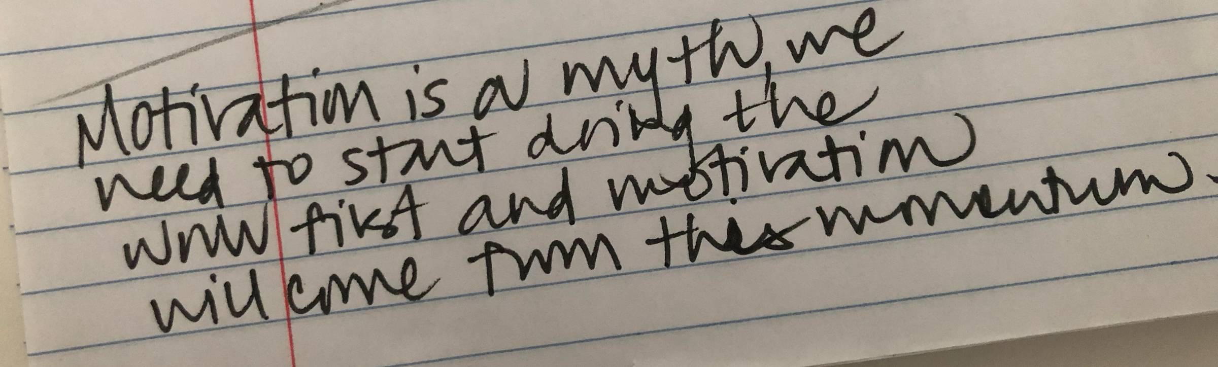 "Motivation is a myth, we need to start doing the work first and motivation will come from this momentum" is written in black ink of a lined paper.