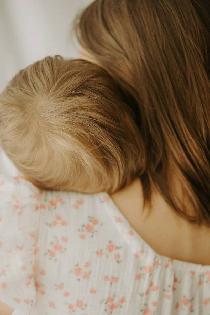 A mother holds her child close and gently.