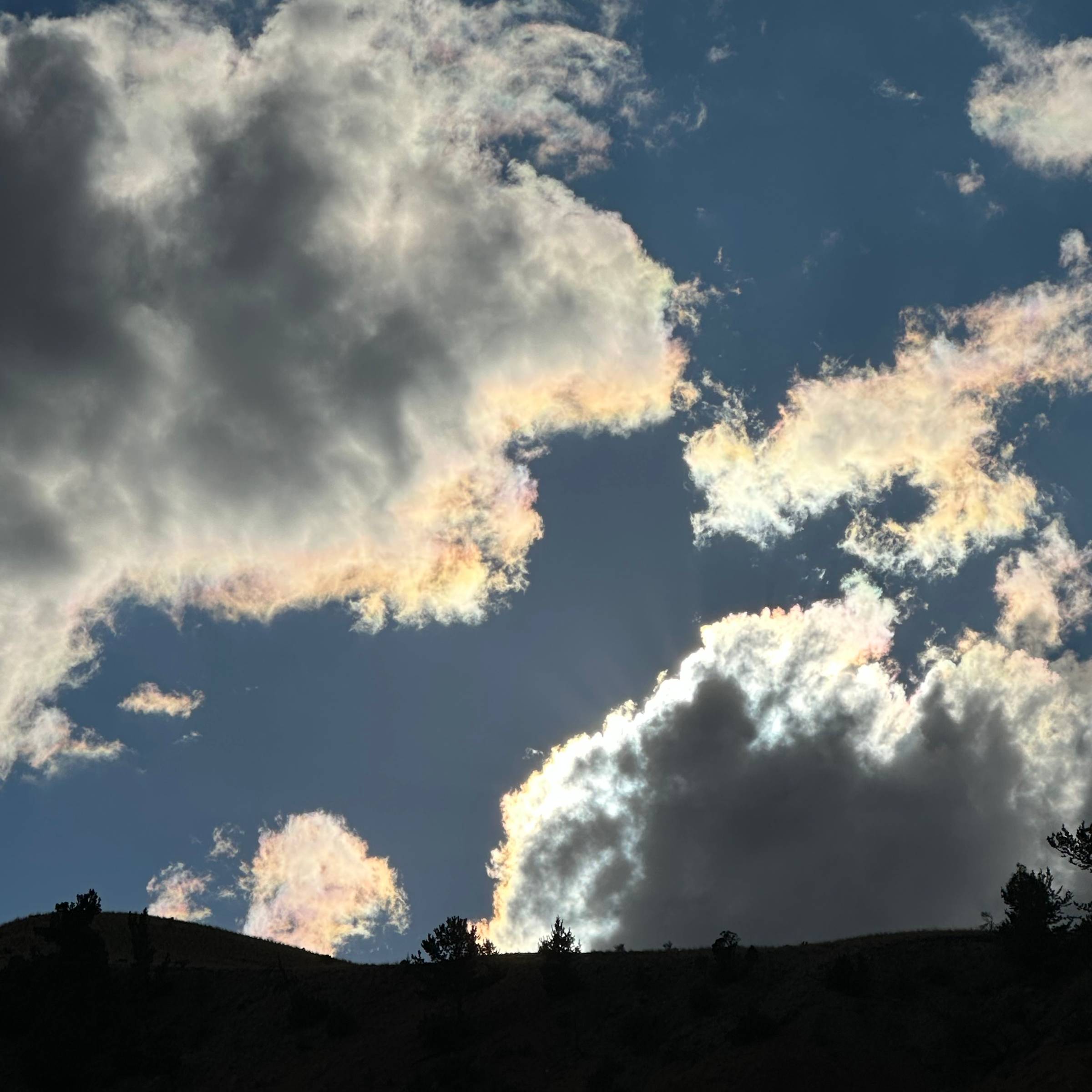 Sun illuminating dark clouds
