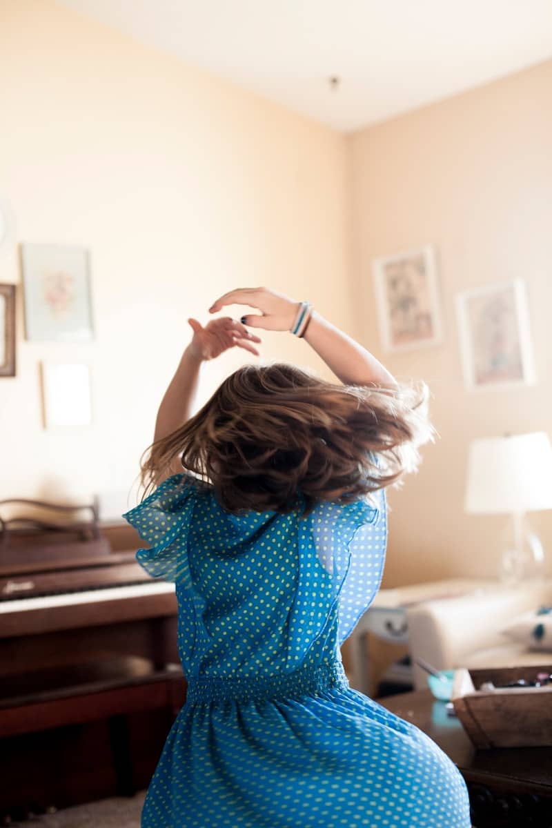 girl twirling around room