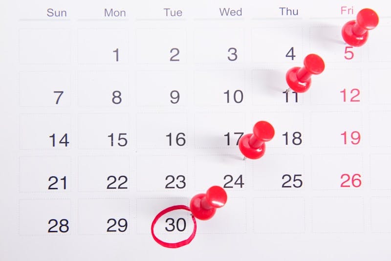  "Calendar showing April events marked with red push pins, highlighting the diverse schedule of activities and meetings."