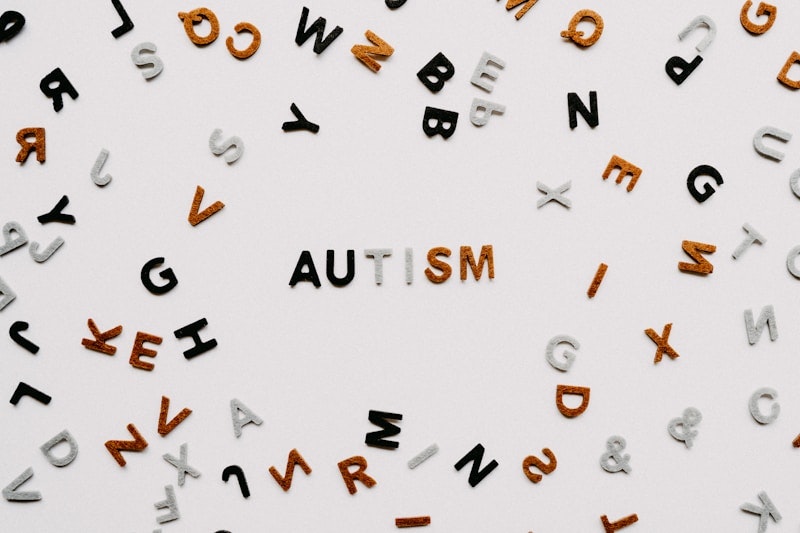 "Colorful scattered letters with the word 'autism' highlighted in the center, symbolizing the diversity and uniqueness of the autism spectrum."