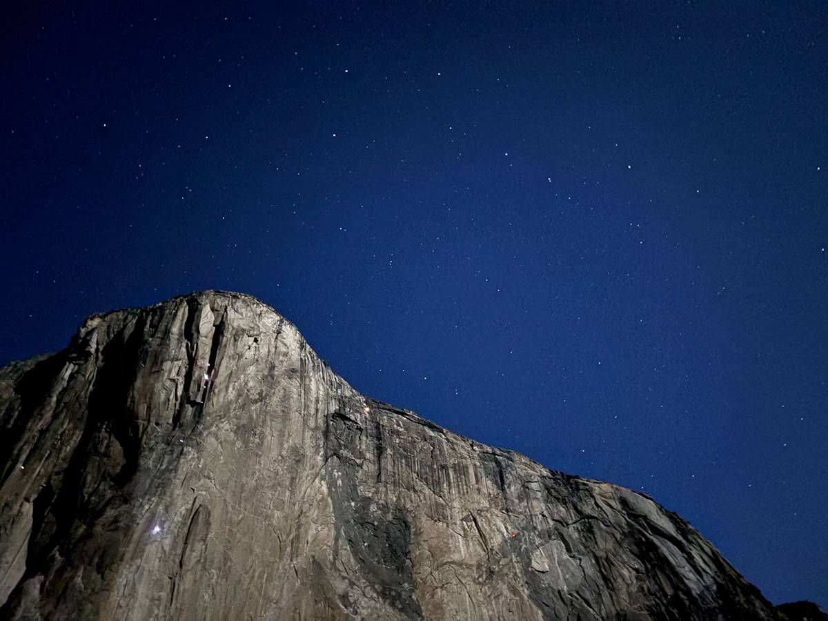 El Capitan at night with the lights of climbers on the wall. 