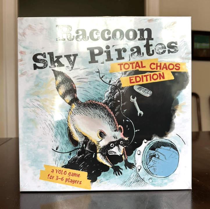 Full-color Raccoon Sky Pirates box, 10 inches on a side and shrink-wrapped, with the same art as the original but in color, & the words Total Chaos Edition on it