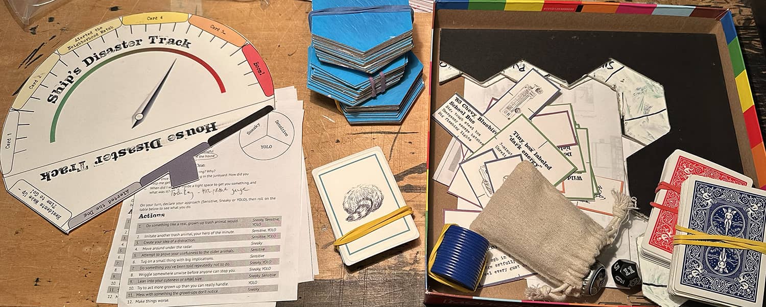 Assorted components for Raccoon Sky Pirates, including a disaster track, hex tiles, playing cards and poker chips