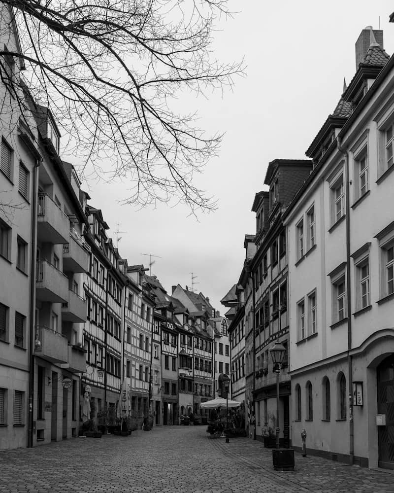 A black and white photo of a cobblestone street