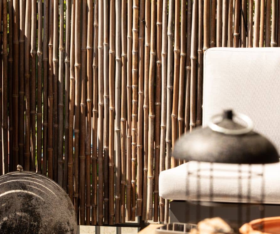 A bamboo privacy fence surrounding a cozy patio.
