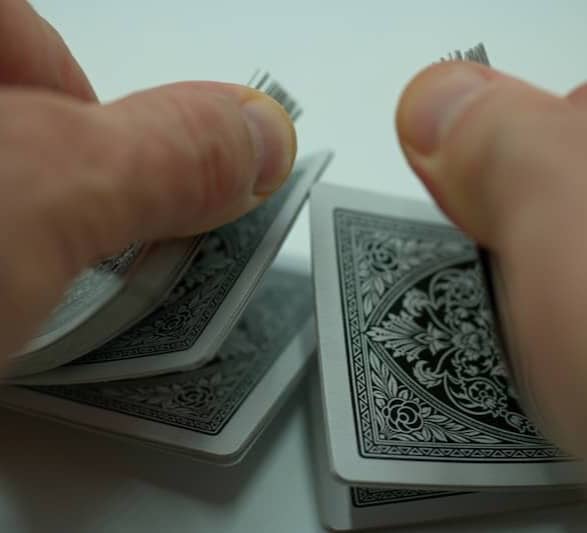 a person holding a piece of playing cards