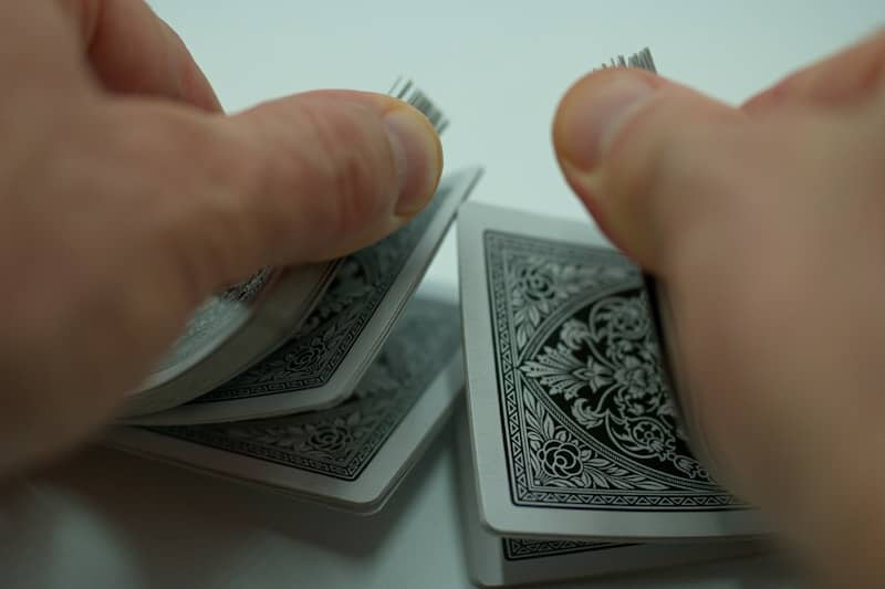 a person holding a piece of playing cards