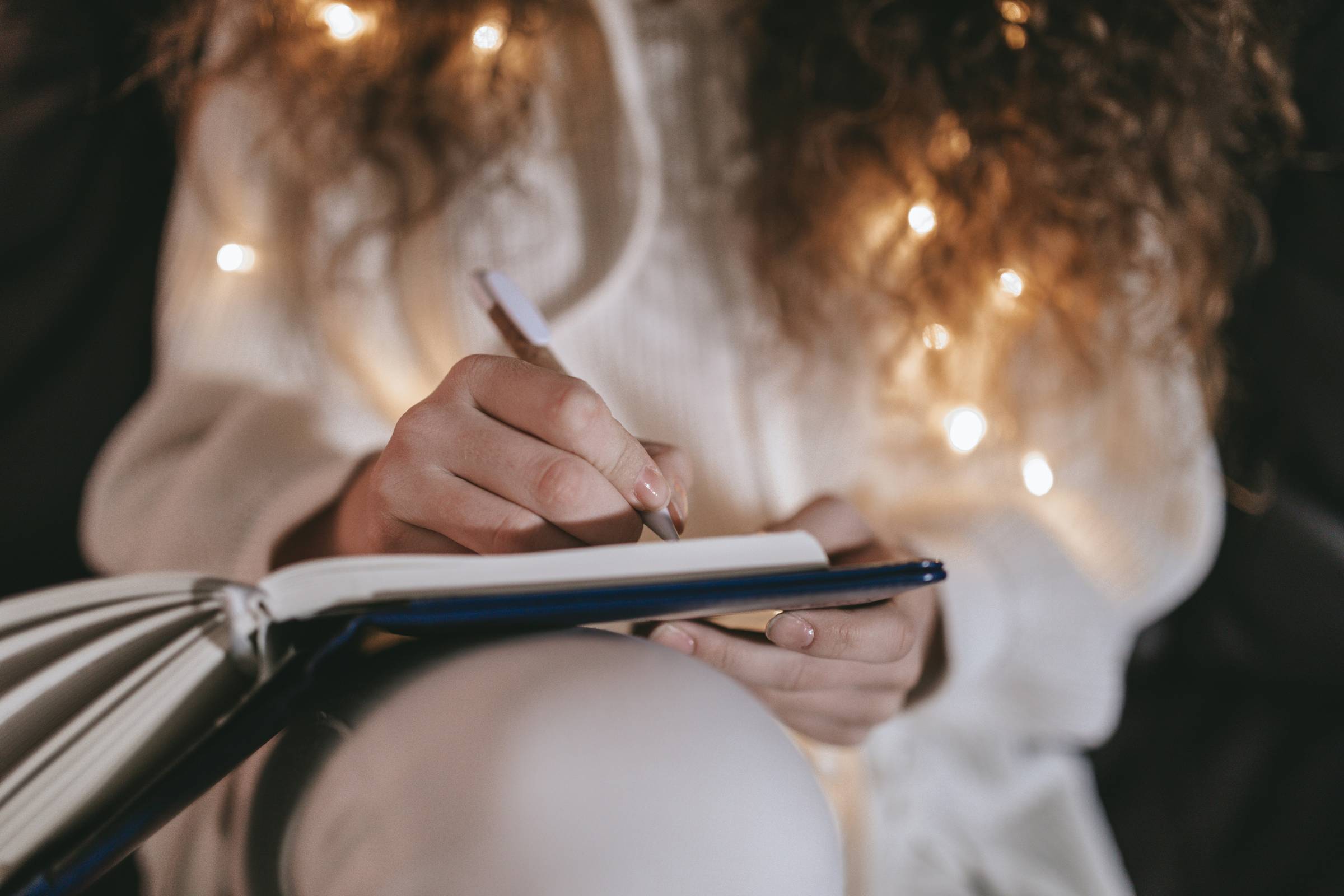 Woman in white journaling at Christmas