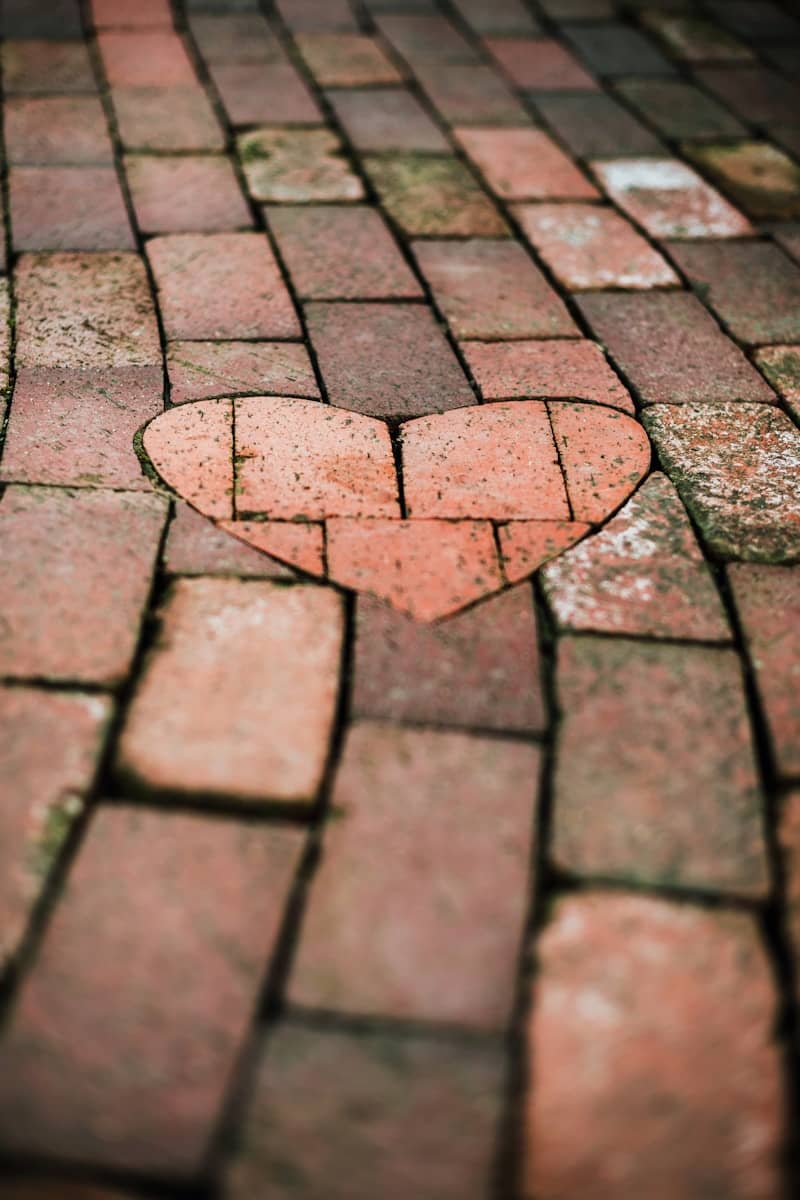 A brick pathway with a heart-shaped inlay