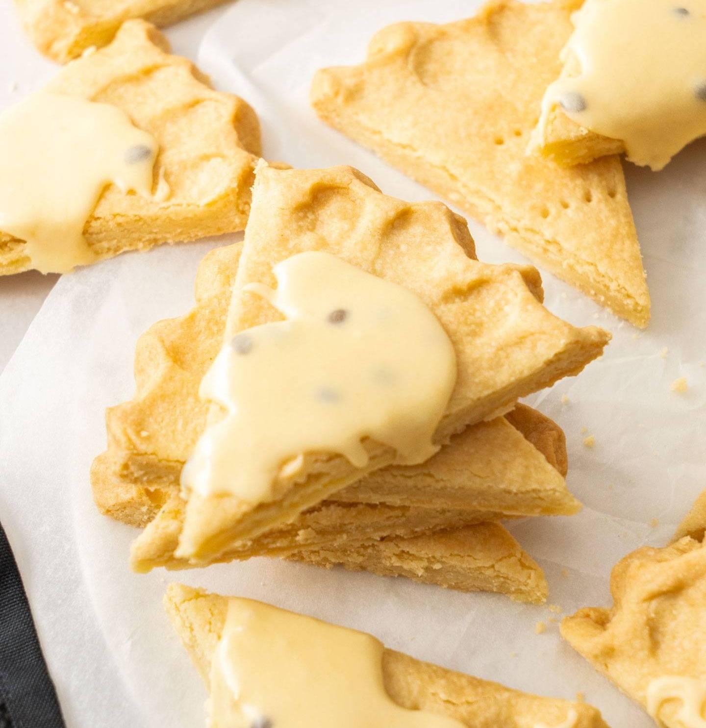 A stack of shortbread triangles topped with passionfruit icing.