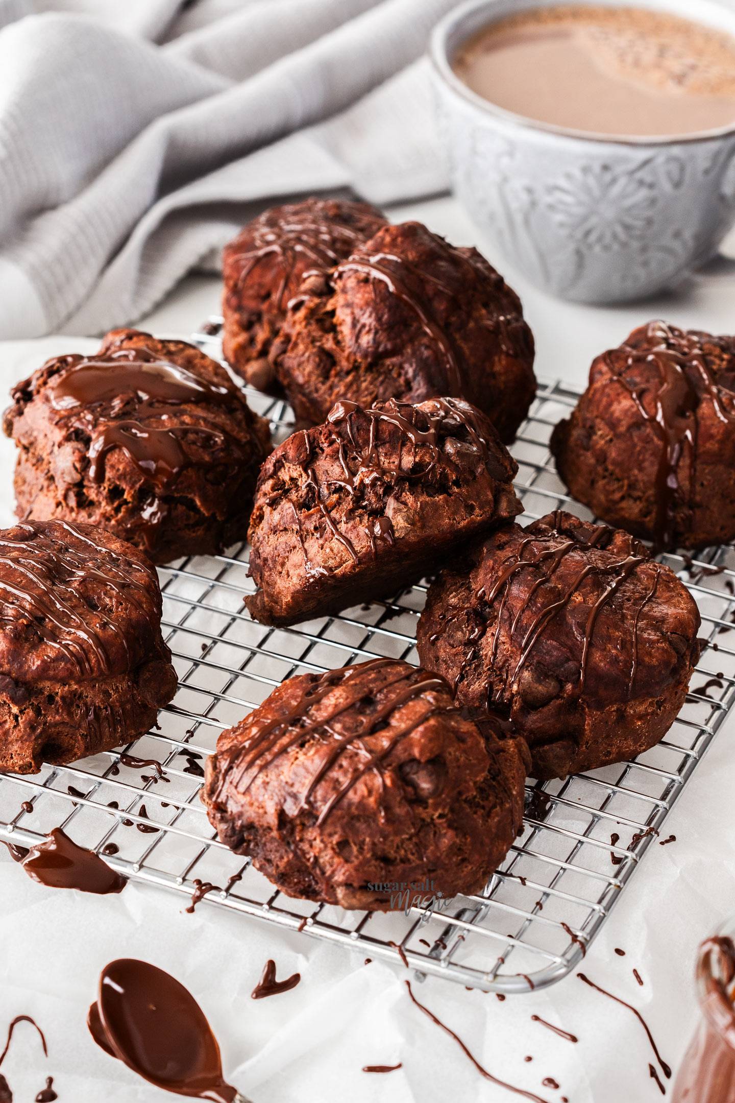 A batch of chocolate scones on a wire rack.