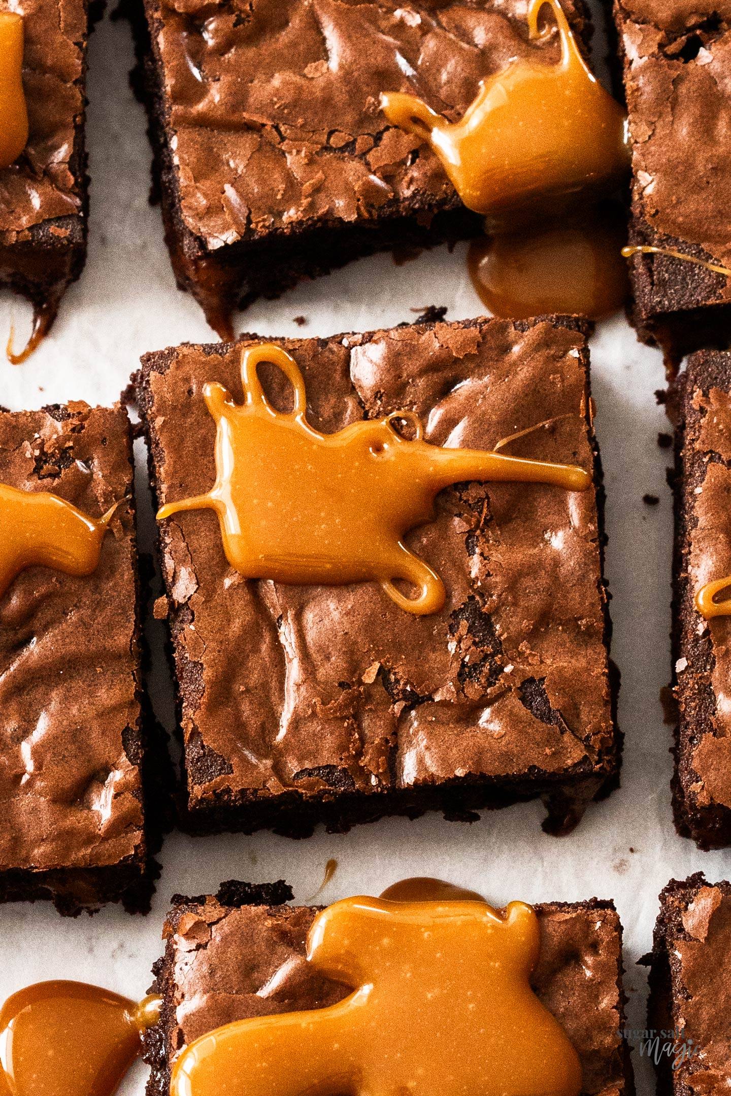 Top down close up of a brownie topped with a dollop of caramel.