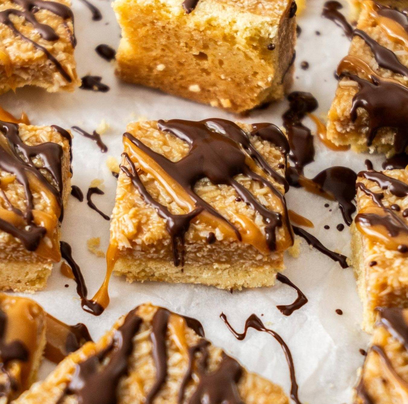 A coconut caramel bar drizzled with caramel and chocolate.
