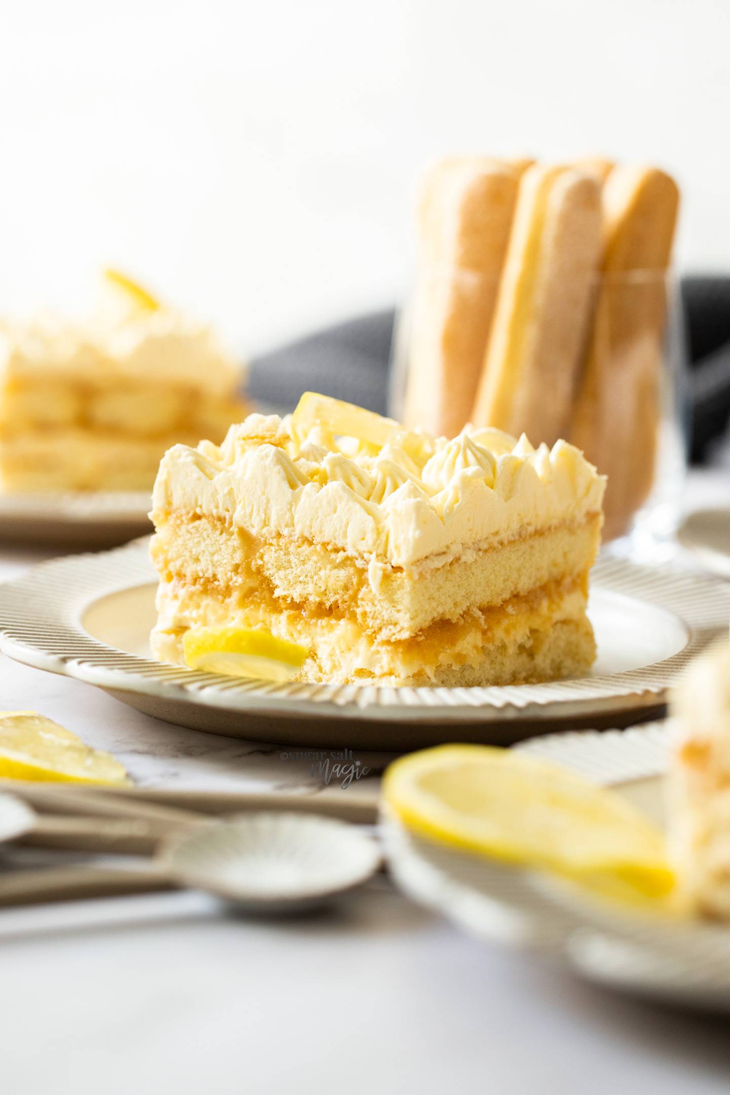 A slice of lemon tiramisu on a dessert plate.