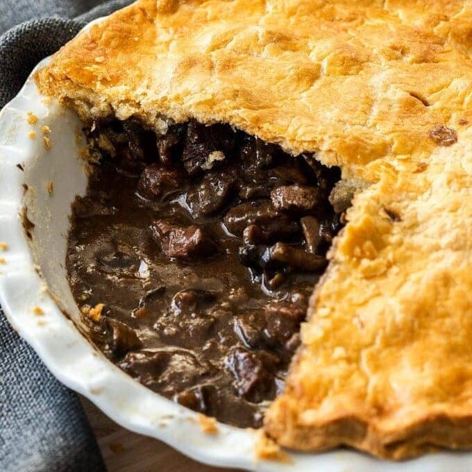 A steak pie cut open to show the inside.