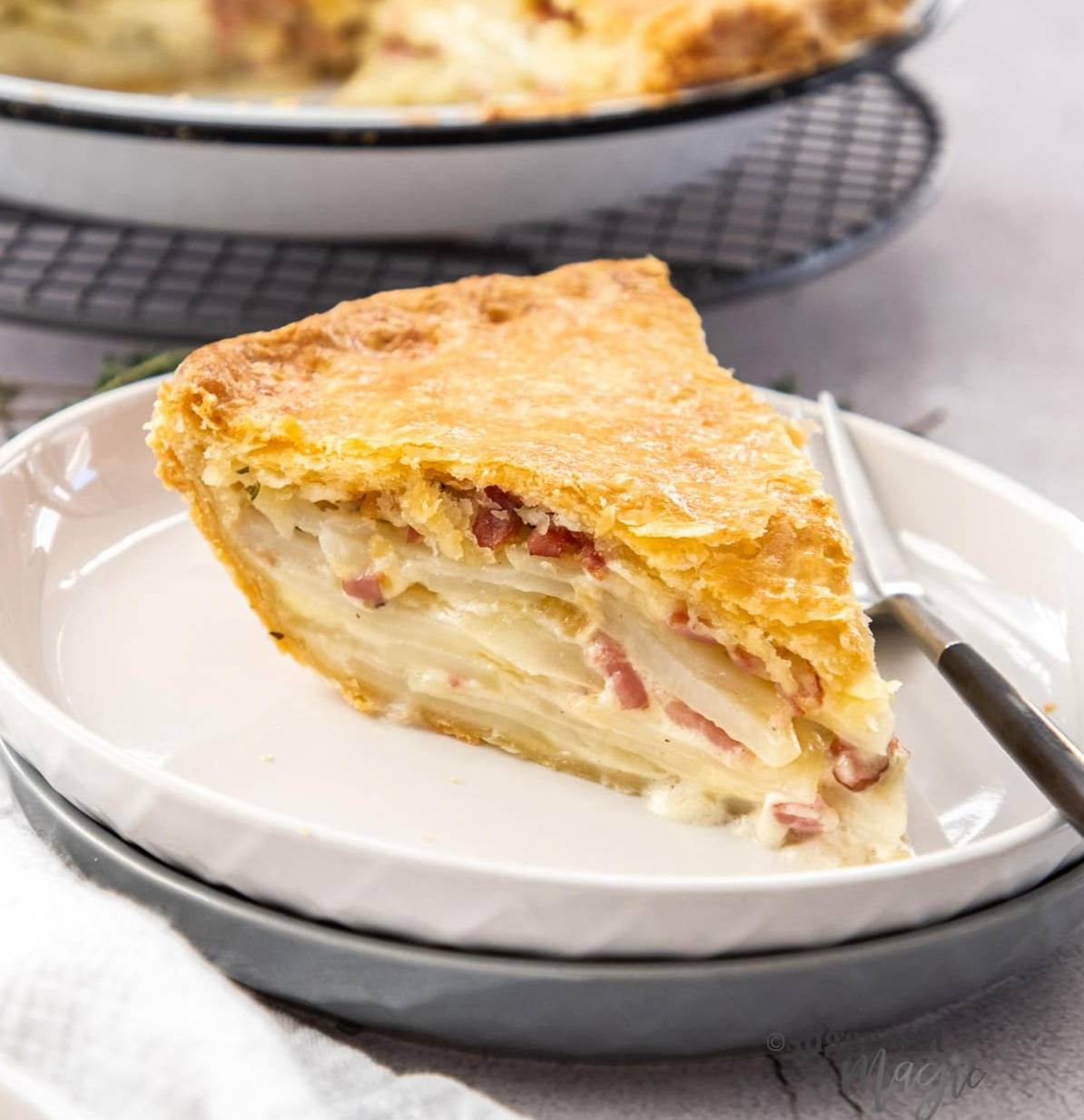 A slice of potato tart on a side plate.