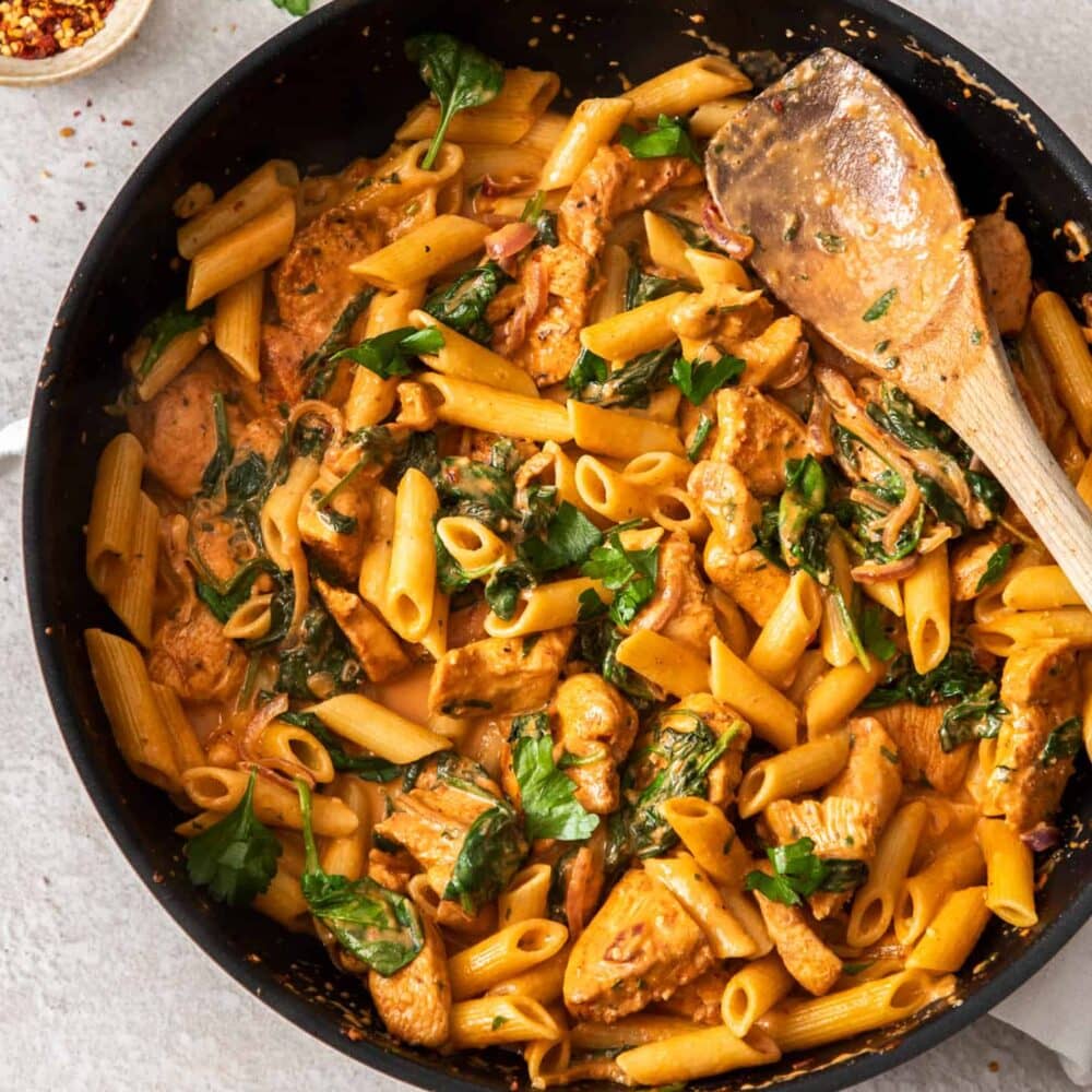Top down view of a pan of spicy chicken pasta.