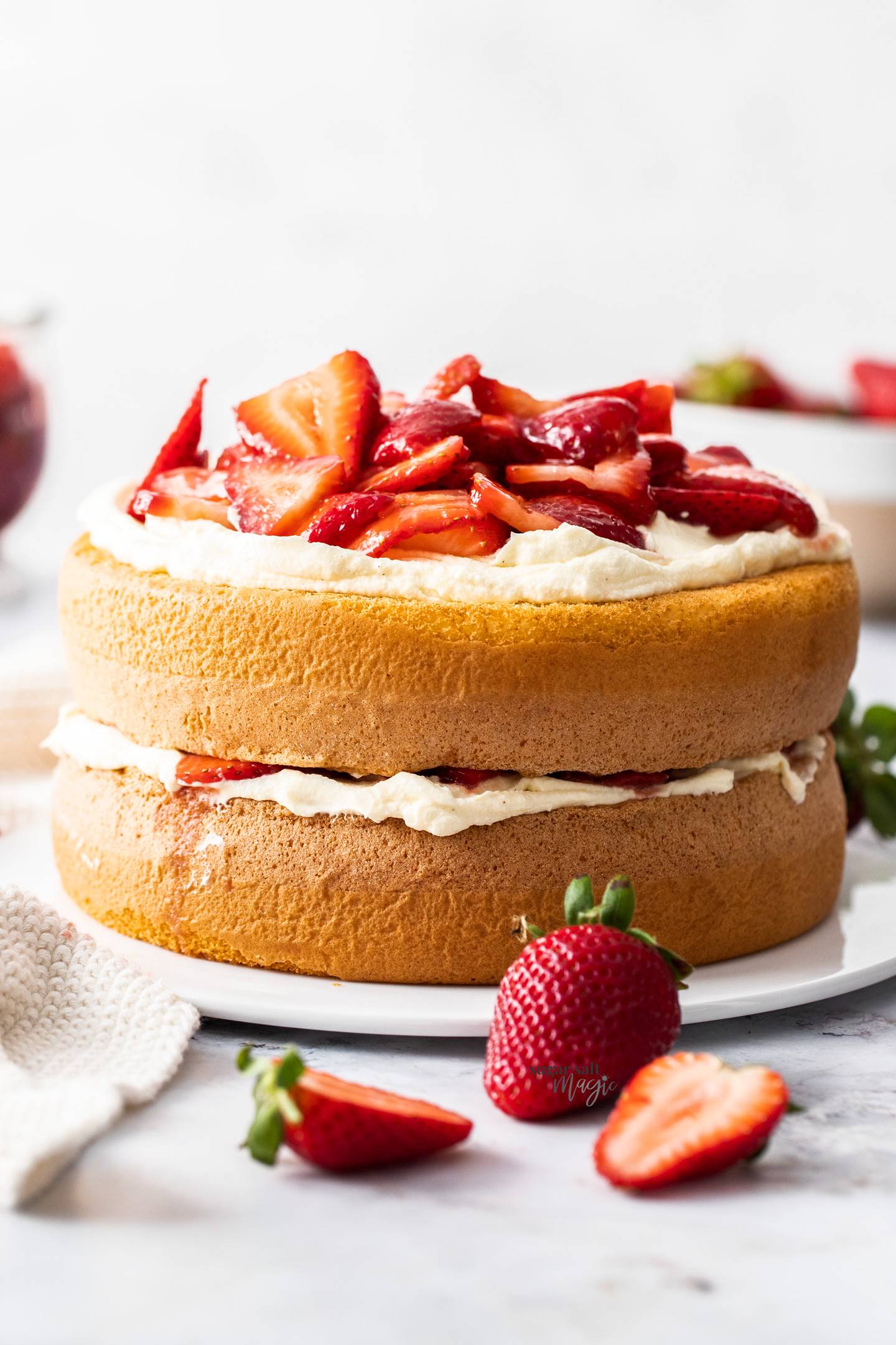 A two layer sponge cake filled with cream and strawberries.